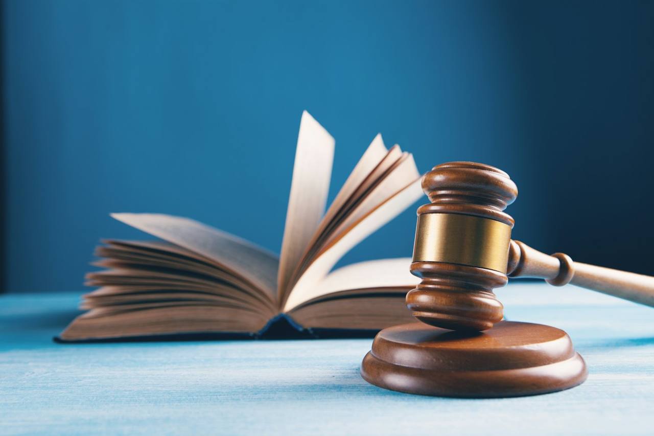 A judge’s gavel next to an open book