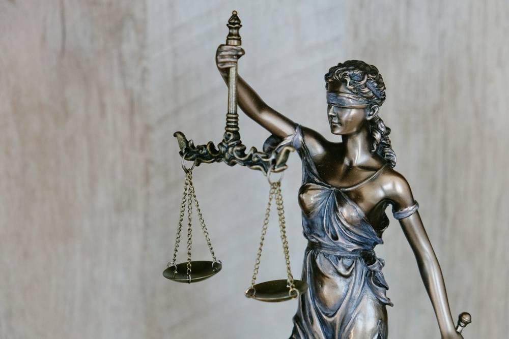 A bronze statue of Lady Justice holding scales