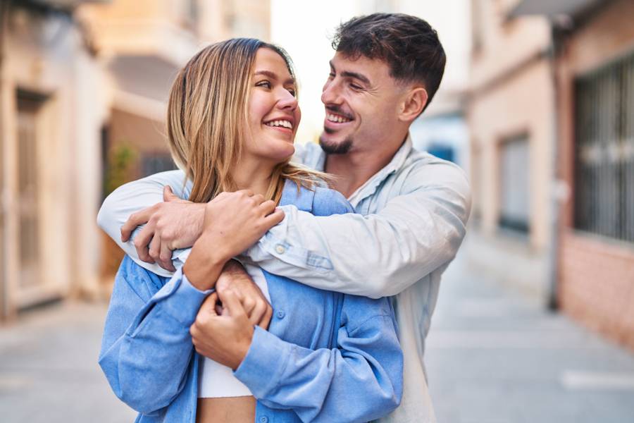 A young couple embracing outdoors