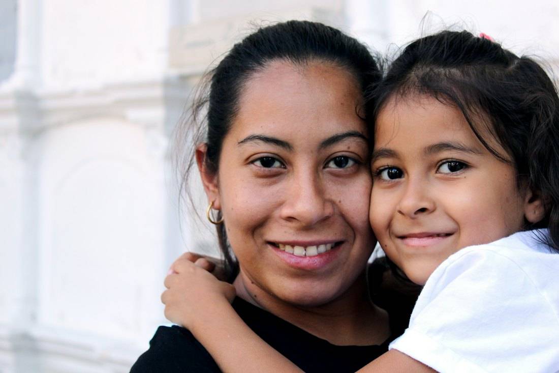 A mother and her daughter smiling